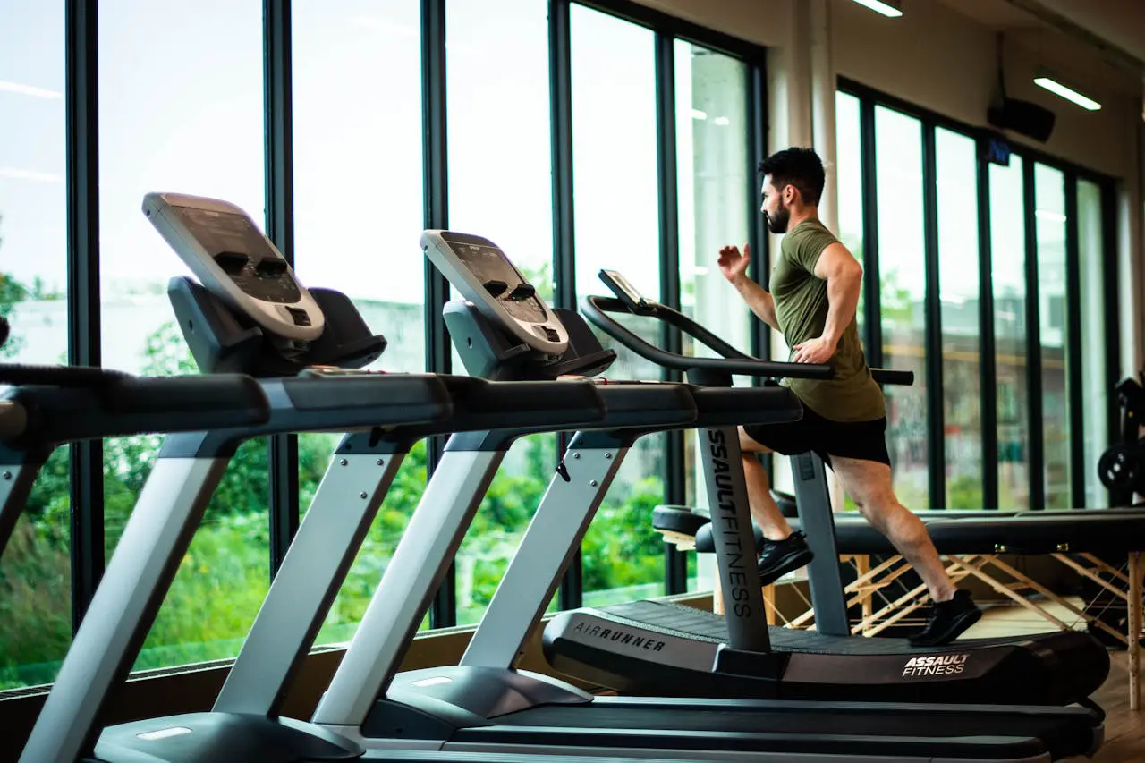 A man is running on some treadmill in the gym